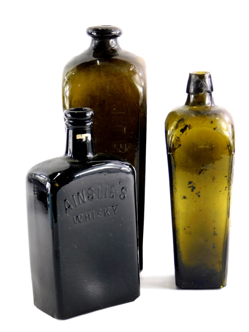 A 19thC green glass whisky bottles for Ainslie's, P.Loopuyt and Co., and J.T.Beukers.