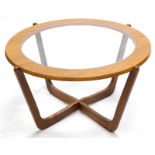 A G-Plan type teak coffee table, the circular top with a smoked glass insert, on X shaped support,