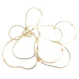 An 18ct gold three layered beaded necklace, the graduated layered design set with three beads to