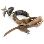 An unusual leather and canvas horse harness, mounted with three bells and an eagle finial.