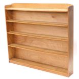 An oak open bookcase, with five shelves and a canted gallery, 128cm high, 139cm wide.