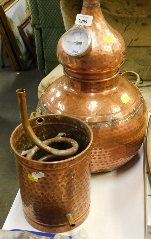 A hammered copper wine or spirit distiller.