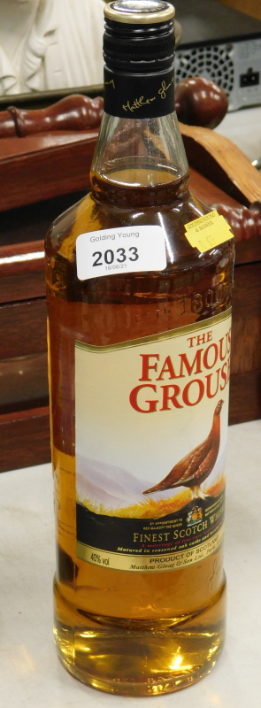 A bottle of Famous Grouse Scotch Whisky.