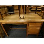 A light oak office desk, with three drawers, the top 121cm x 69cm.