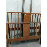 An Edwardian mahogany double bed frame, comprising headboard, and foot, and metal side rails,