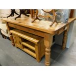 A pine kitchen table, on turned legs, the top 140cm x 87cm.