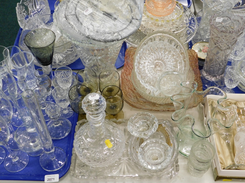 A quantity of glassware, to include vases, commemorative champagne flutes, part dressing table