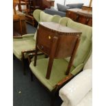 An oak sewing table, and a pair of upholstered armchairs. The upholstery in this lot does not comply