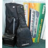 A Casio key lightening keyboard, LK-55, boxed, with outer canvas case, an electric guitar, and a C.