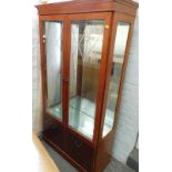 A cherrywood display cabinet, the top with two glazed hinged doors, with two doors to base.