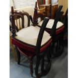 A set of four Victorian mahogany balloon dining chairs, each with a lobed back, a padded seat on