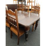 An oak extending dining table, on turned and reeded legs, with leaf, and a set of four Edwardian