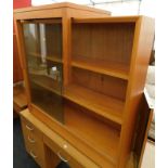 A Herbert E Gibbs glazed front bookcase, and a teak coffee table.