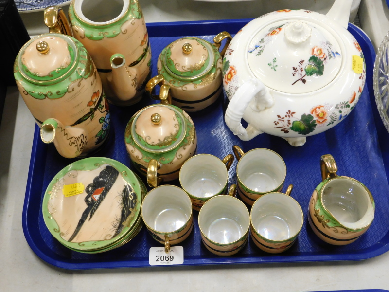 An oriental style part tea service, and a teapot decorated with flowers.