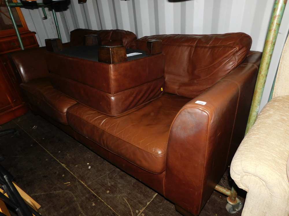 A three seater sofa, upholstered in brown leatherette, together with a matching footstool. (2)