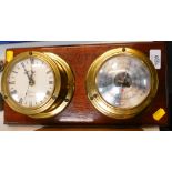 A brass hanging Robinclox quartz clock and barometer, with flame mahogany finish back.