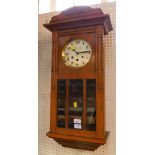 A 1920's oak chiming wall clock, with eight day movement and Arabic dial, partial glazed fronted cas