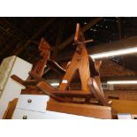 A pair of teak rocking horses, approx 70cm high, 80cm wide, 34cm deep.