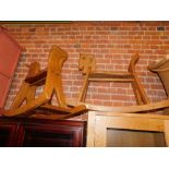 A pair of teak rocking horses, approx 60cm high, 90cm wide, 33cm deep.