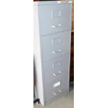 A four drawer silvered metal filing cabinet.
