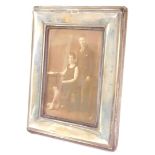 A George V silver strut photograph frame, of rectangular form, London 1917, 17.5cm high, 13.5cm wide