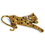 A 9ct gold leopard brooch, the body set with various sapphires, with a tiny diamond set white gold c