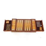 A hardwood backgammon board, of rectangular form with pressed sections and interior drawers set with