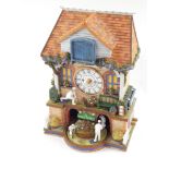 A Bradford Exchange The Spirit of Bowls resin free standing cuckoo clock, marked to the back, 33cm h