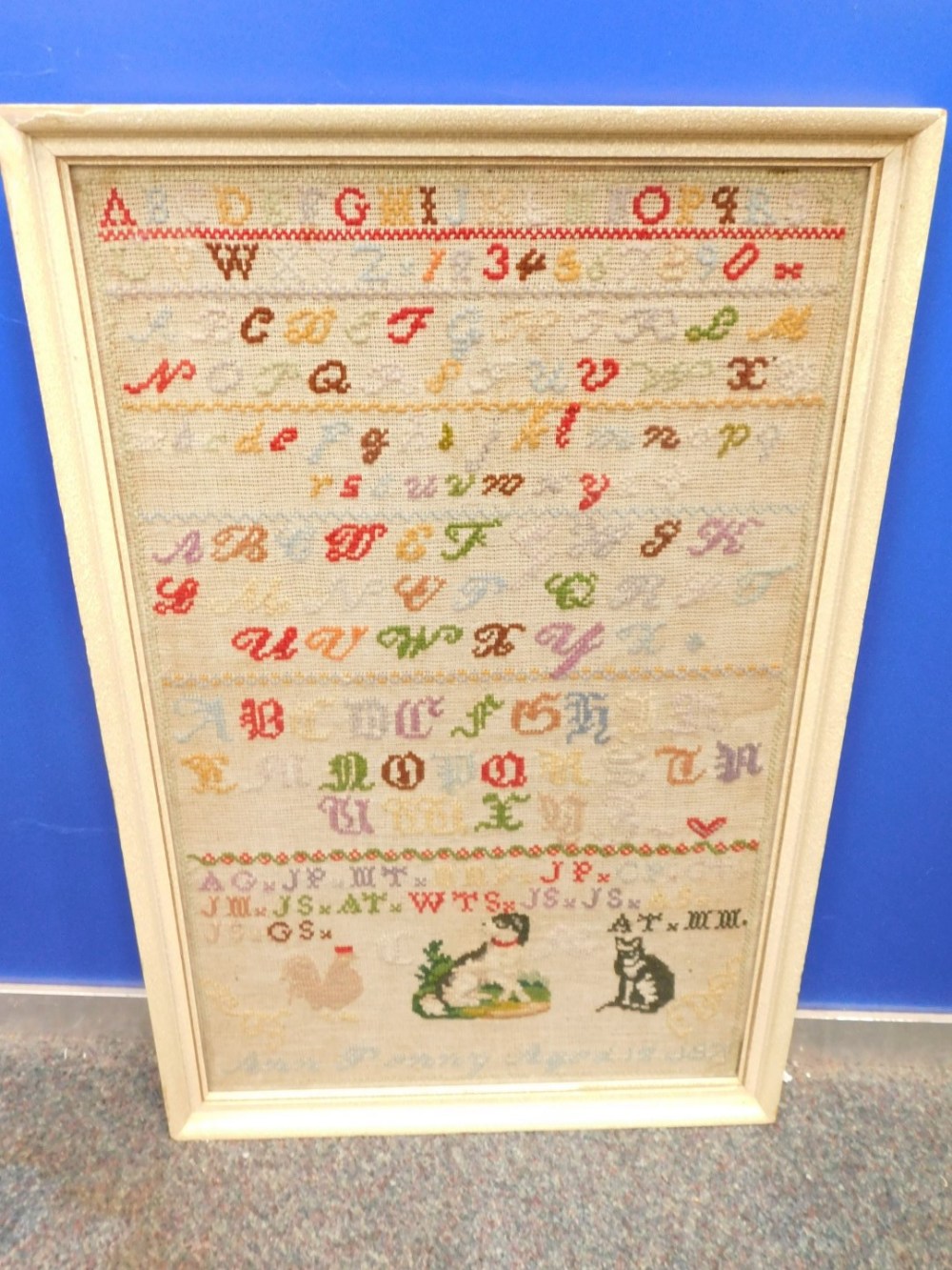 A Victorian alphabet sampler by Anne Penny, aged 12, dated 1871, depicting alphabets, a dog, cat and - Image 2 of 2