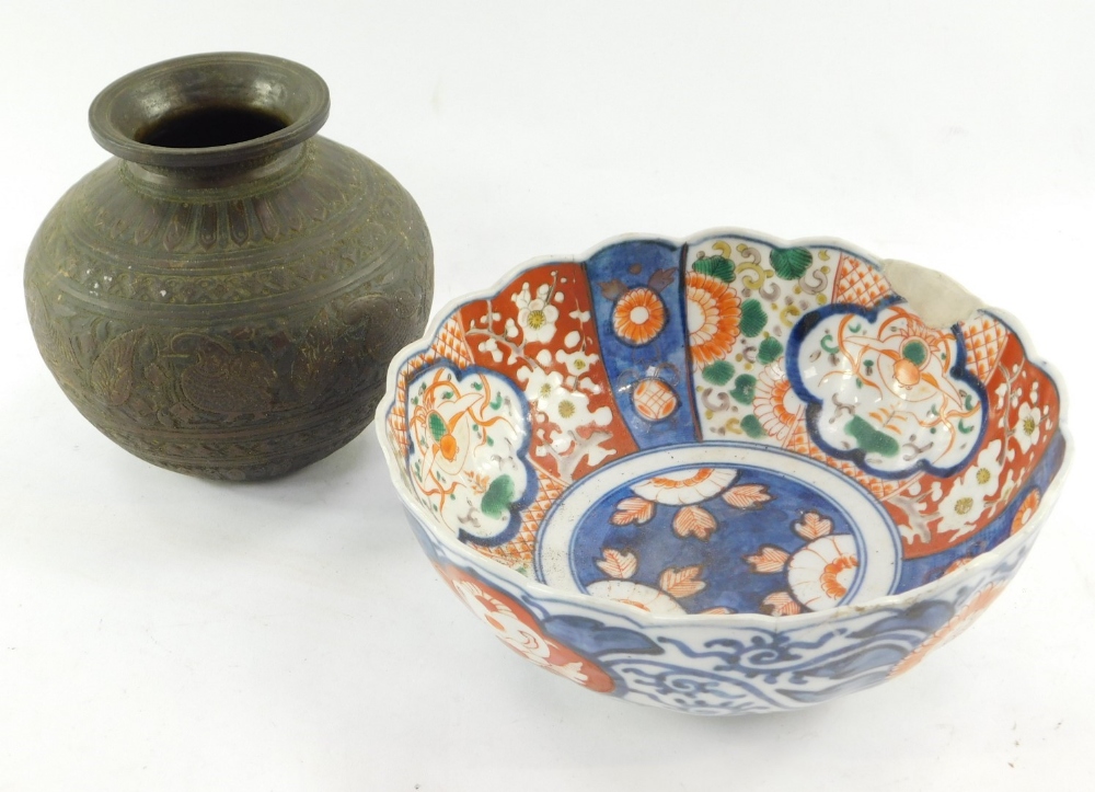 A late Meiji period Japanese Imari bowl, of shaped floral form, 22cm wide, and a brass vase of circu