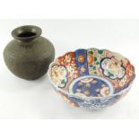 A late Meiji period Japanese Imari bowl, of shaped floral form, 22cm wide, and a brass vase of circu