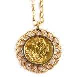 A George V full gold sovereign pendant and chain, dated 1913, in a floral design border, on a curb l