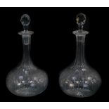 A pair of Edwardian cut and etched glass globe and shaft decanters, with faceted stoppers, 24cm high