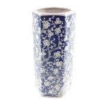 A Chinese porcelain stick stand, of hexagonal form, decorated with prunus blossom against a blue gro