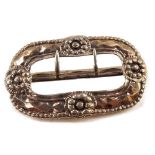 A 19thC buckle, white metal, embossed with flowerheads, bears marks, 8cm wide.