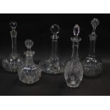 A group of decanters and stoppers, comprising three globe and shaft decanters, a ship's decanter and