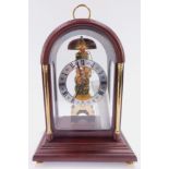 A Hermle mahogany cased skeleton clock, with silvered chapter ring bearing Roman numerals, brass mov