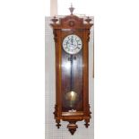 J A Nystorm Stockholm. An early 20thC walnut cased two weight Vienna wall clock, in heavily carved c