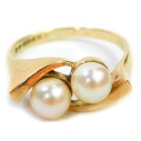 A 9ct gold cultured pearl set dress ring, with two cultured pearls in twist design raised shoulders,