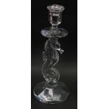 A Waterford crystal candlestick, raised on a seahorse shaped stem, over a circular base, 29cm high.