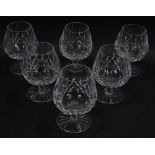 A set of six Waterford crystal brandy balloons decorated in the Lismore pattern.