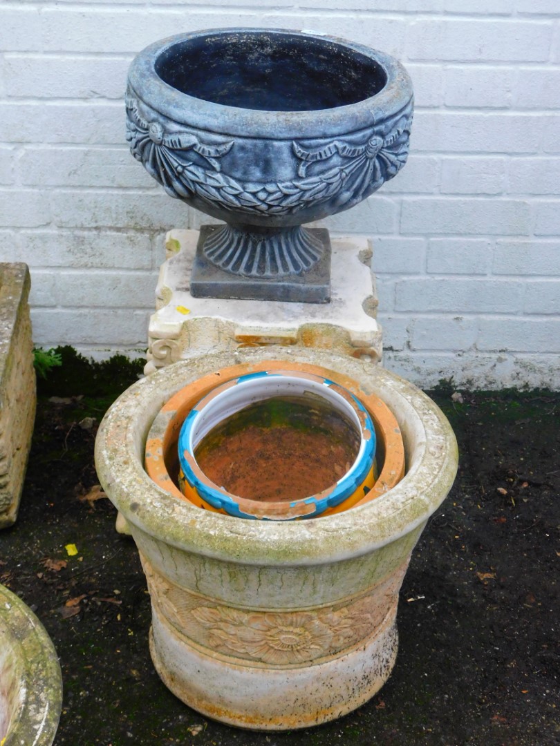 A pair of concrete bench sections, and a classic design urn of circular form on square form, 37cm hi