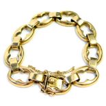 A 9ct gold fancy link bracelet, with large oval cut out links joined by curb links, with safety chai