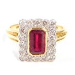 An 18ct gold ruby and diamond dress ring, with rectangular cut, central ruby in rub over yellow gold