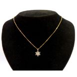 A 9ct goldstar pendant and chain, the pendant set with various tiny diamonds, both round brilliant c