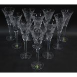 A group of ten Waterford crystal champagne flutes, decorated in Millennium Universal Wishes pattern.