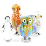 Three Monschau glass figures modelled as owls, 21/28cm high, together with a figure of a penguin, 19