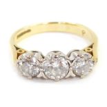 An 18ct gold three stone diamond ring, the central round brilliant cut stone in four claw setting, 4