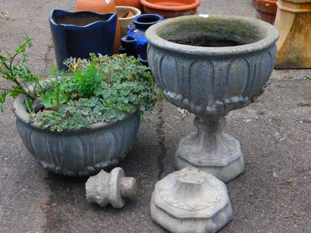 A near matching pair of classical designed planters, each of circular form raised with scrolls and f