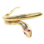 A 9ct gold snake articulated bracelet, with a steel internal spring, the head set with two garnet ey